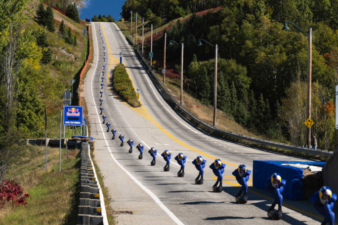 Time lapse of Diego going down the hill past the sign