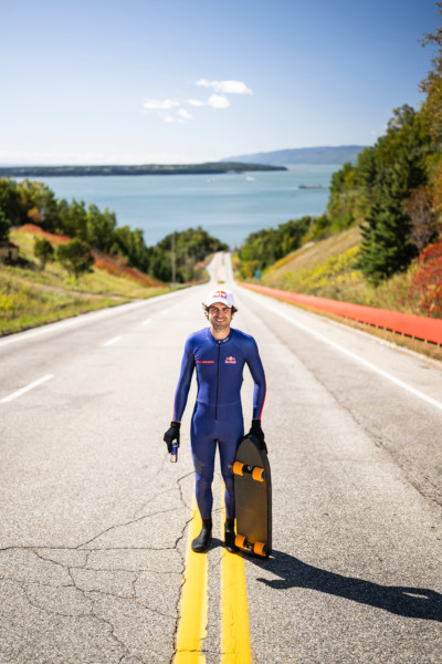 Diego at the top of the hill, holding his skateboard