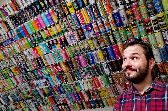 record holder posing in front of cans
