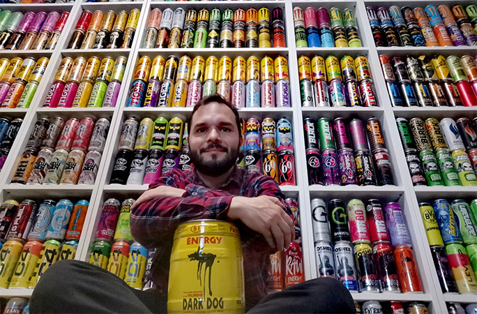 record holder posing with a giant can of energy drink