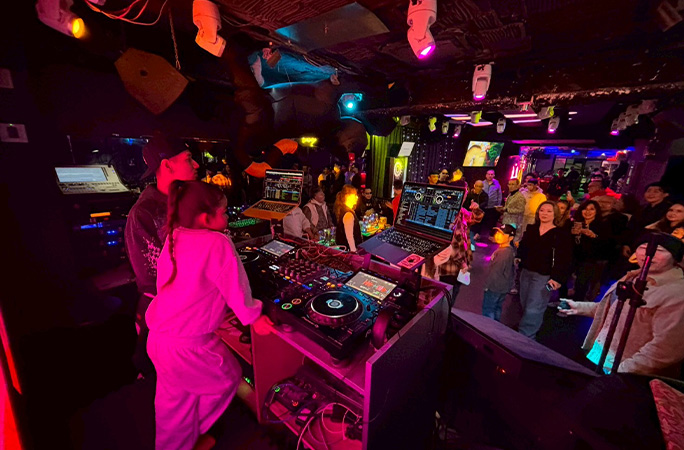Illumi in DJ booth performing