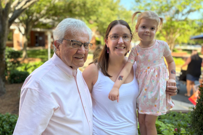 Normand, Kerry, and Madison posing for a photo outside