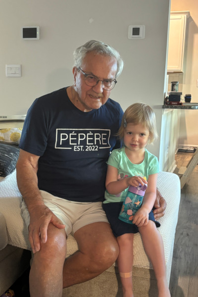Normand wearing a shirt that says 'Pepere' with toddler Madison