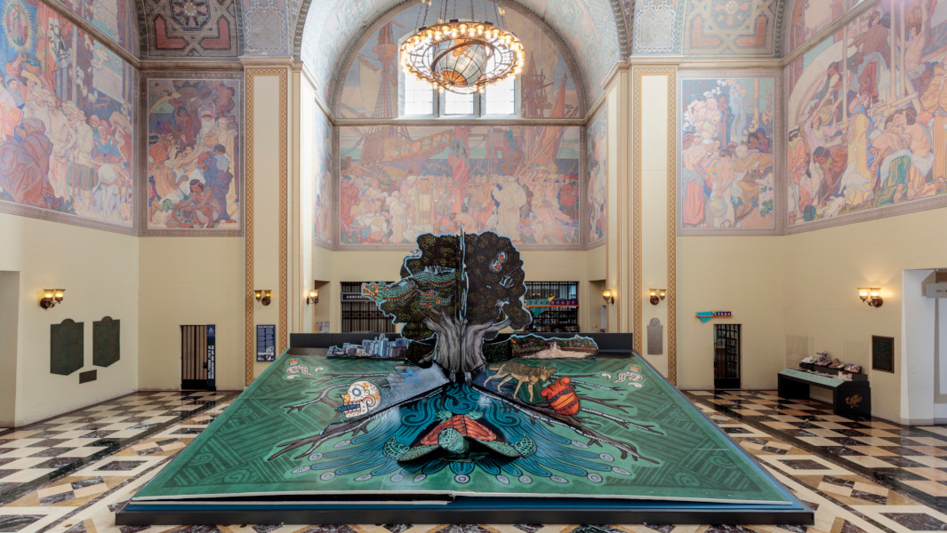 The pop up book opened to the tree page on display at the Riordan Library