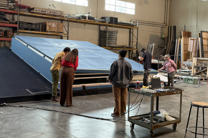 Volunteers looking at the book in the warehouse