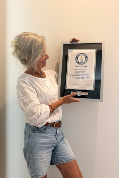Yvette smiling at her certificate
