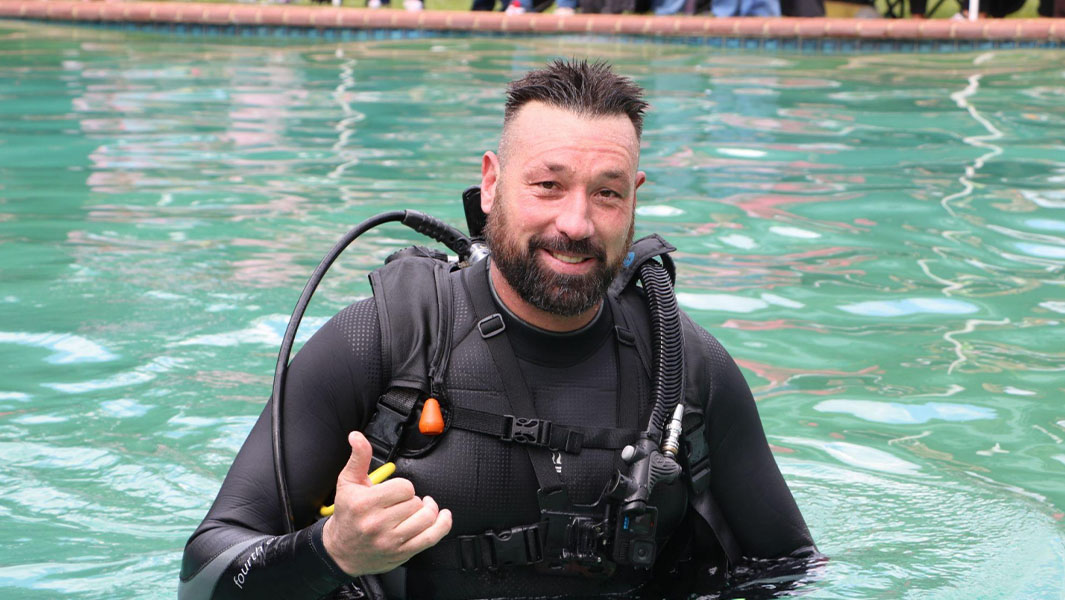split image of Andre in scuba gear and underwater doing a haircut