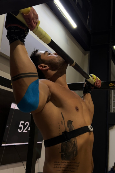 Closeup shot of Enrique doing a pull up