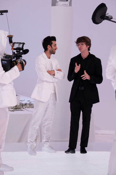 Jon directing in a white suit