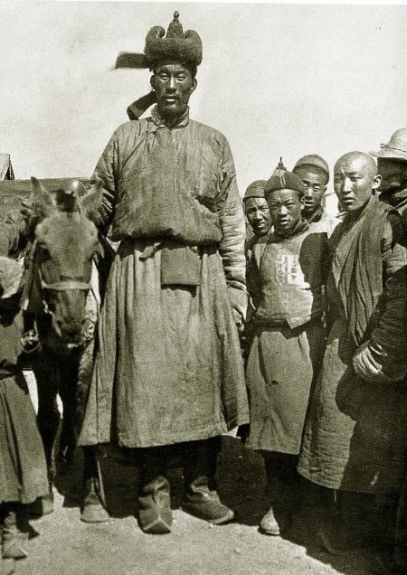 A street scene showing Ondor Gongor standing in a crowd