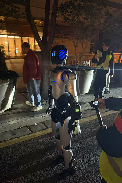 people taking pictures of the robot