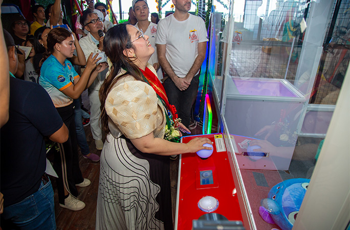 woman playing claw machine
