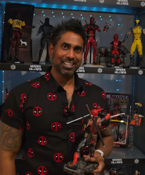 Greg holding a Deadpool figurine