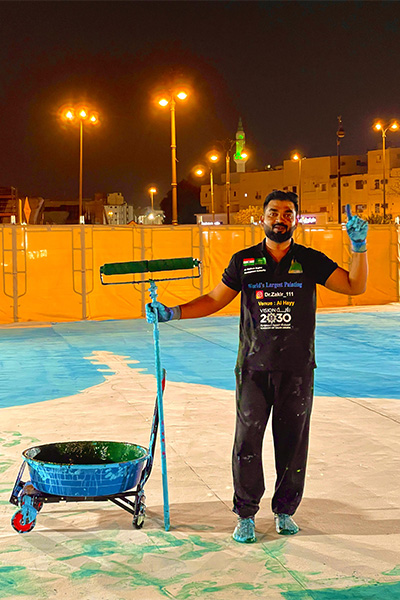 Zakir posing with a paint roller