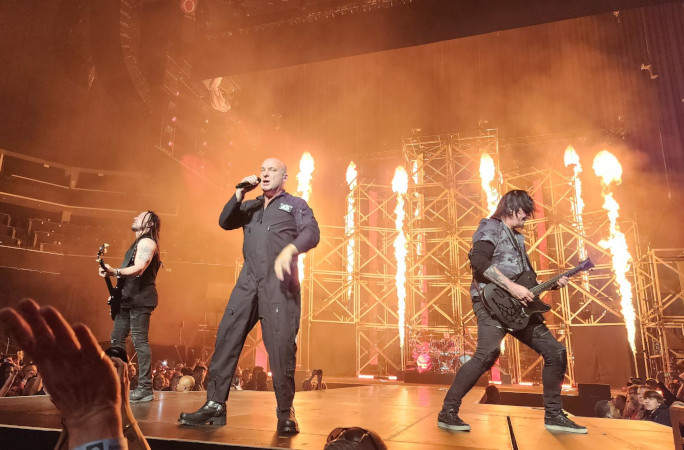 Metal performers rocking out in front of a fire