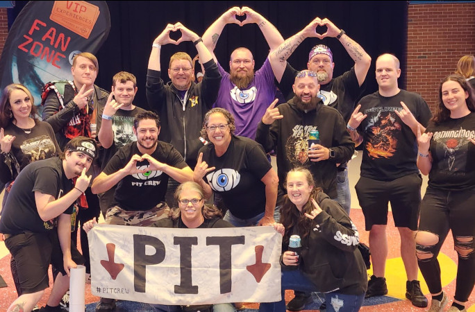 Tim's pit crew family throwing up heart signs