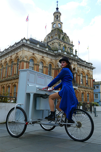 Chloe sitting at her piano