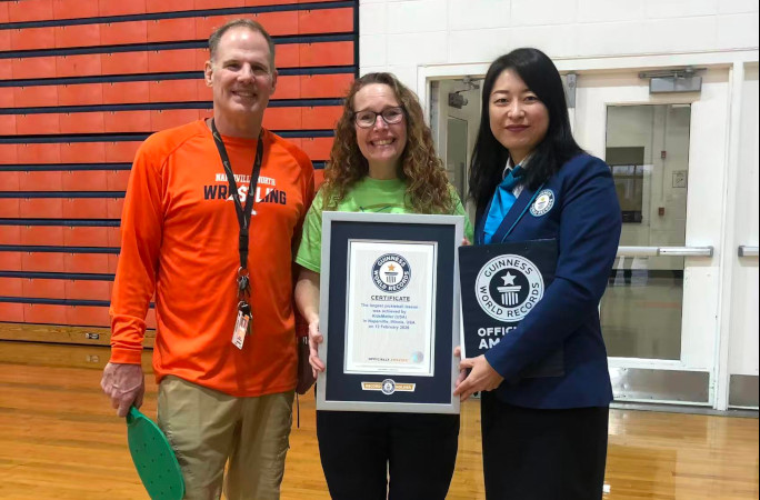Organizers of the largest pickleball lesson posing with the certificate