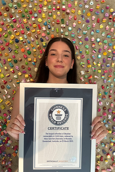 Alexa with her GWR certificate and surrounded by Shopkins