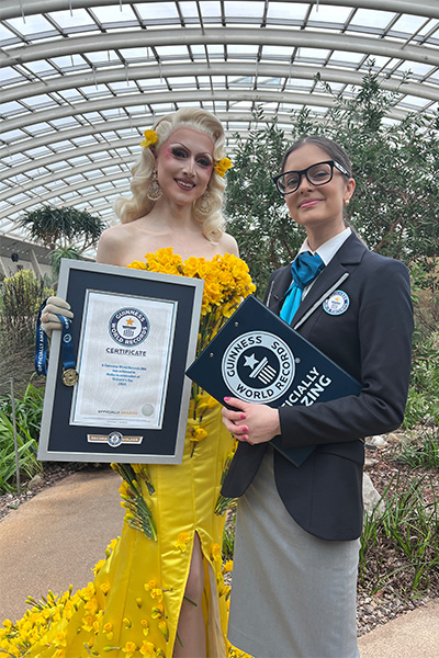 Drag queen Marmalade in her record-breaking daffodil dress with a GWR adjudicator
