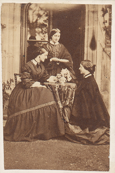 Three victorian women having tea