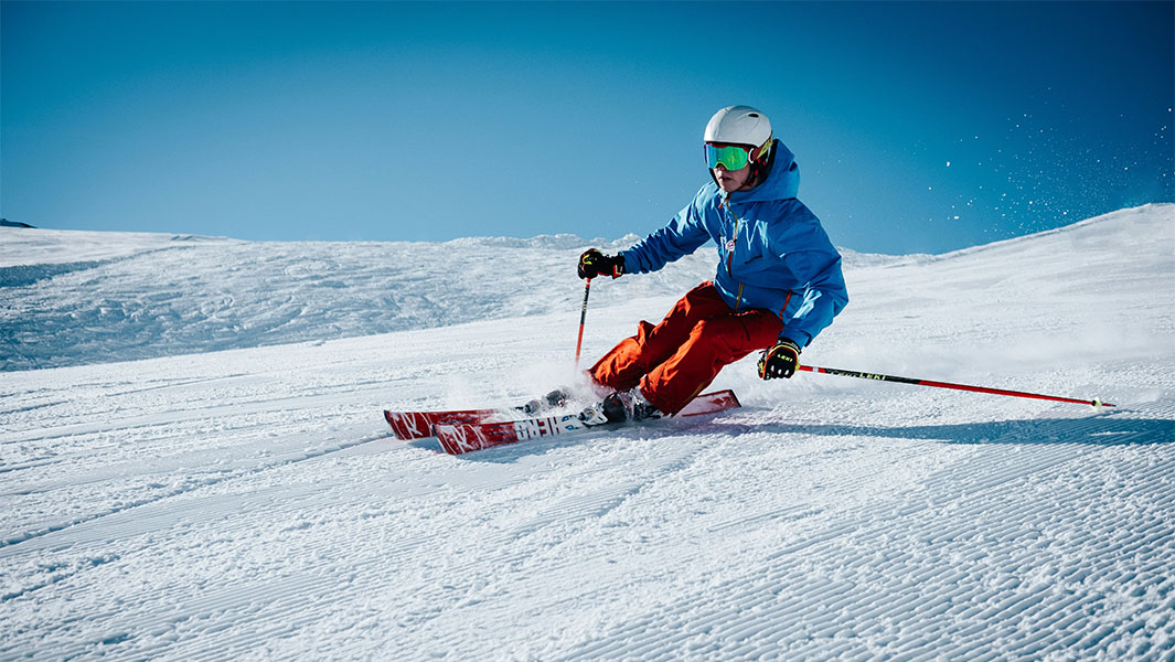 a skiier going downhill