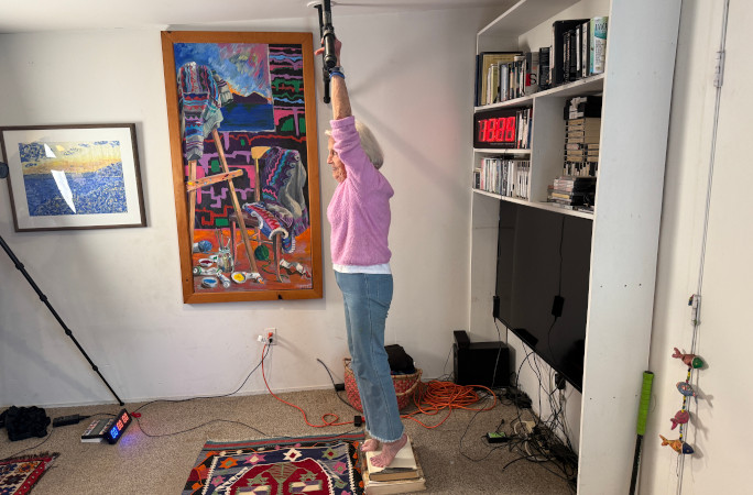 Ann before her attempt, standing on books under the bar