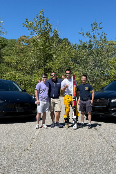 Close up of Johnny and his witnesses next to the cars from the attempt
