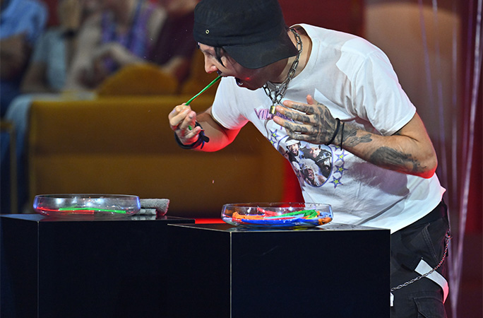 man pulling a balloon out of his mouth