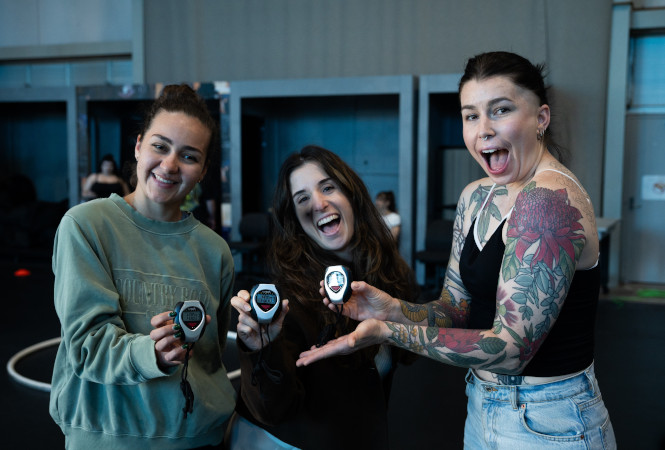 Sophie Bohlsen and her friends holding stopwatches and smiling