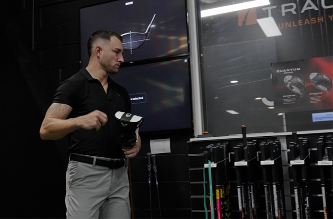 Thomas looking at golfing equipment