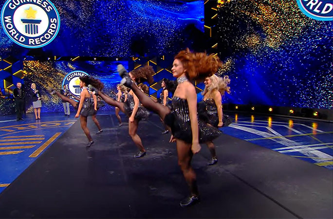 ladies kicking their legs up