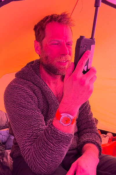 jonny-huntington-in-tent-calling-his-team-to-update-them-on-his-progress