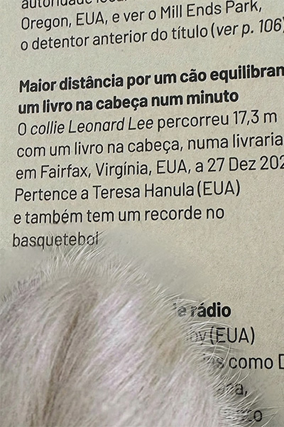 Leonard pointing to his record in the book with his paw