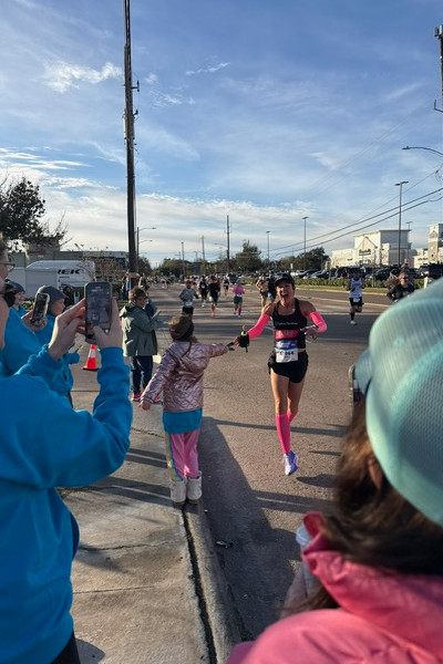 Carrie giving a little girl a high-five during her run