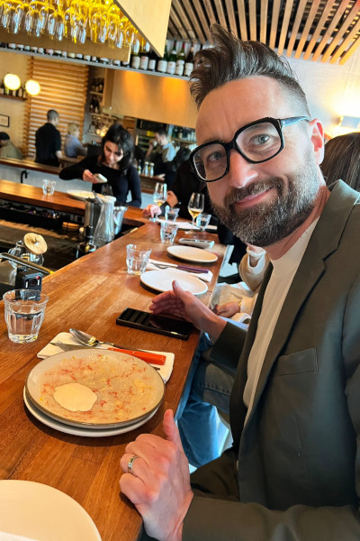 Josh at a bar counter eating food
