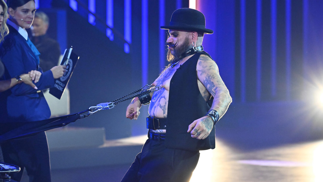 The Baron pulling a vehicle with his nipple piercings