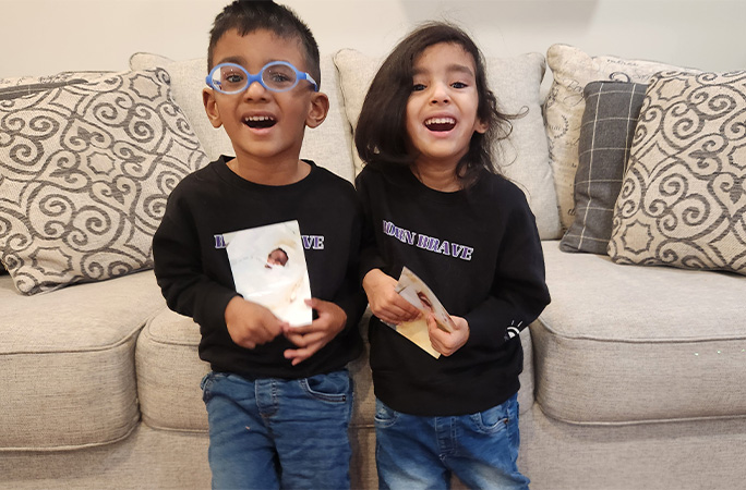 the prem twins holding their baby pictures