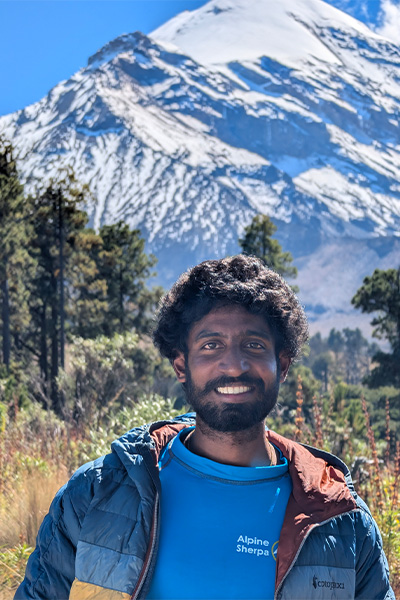Anmish standing in front of a mountain
