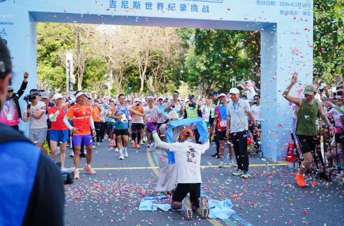 Long Shao on his knees after crossing the finish line