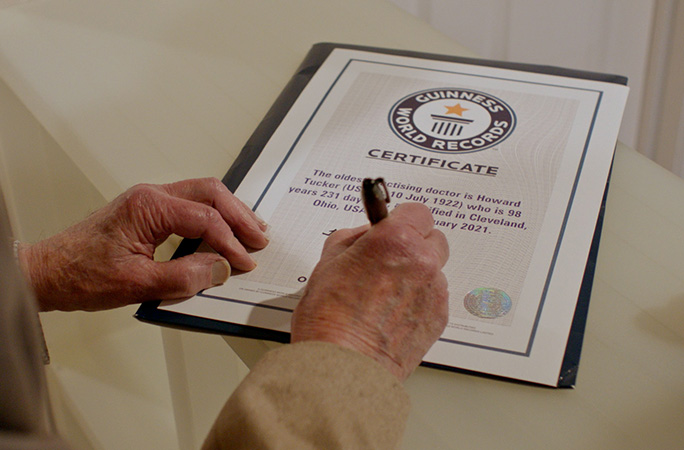 Dr Howard signing his GWR certificate