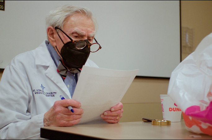 Dr Howard looking at papers