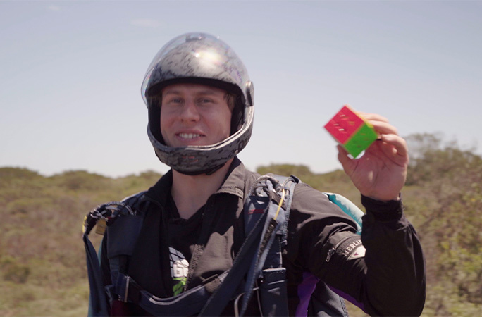 Tom holding his completed cube on the ground