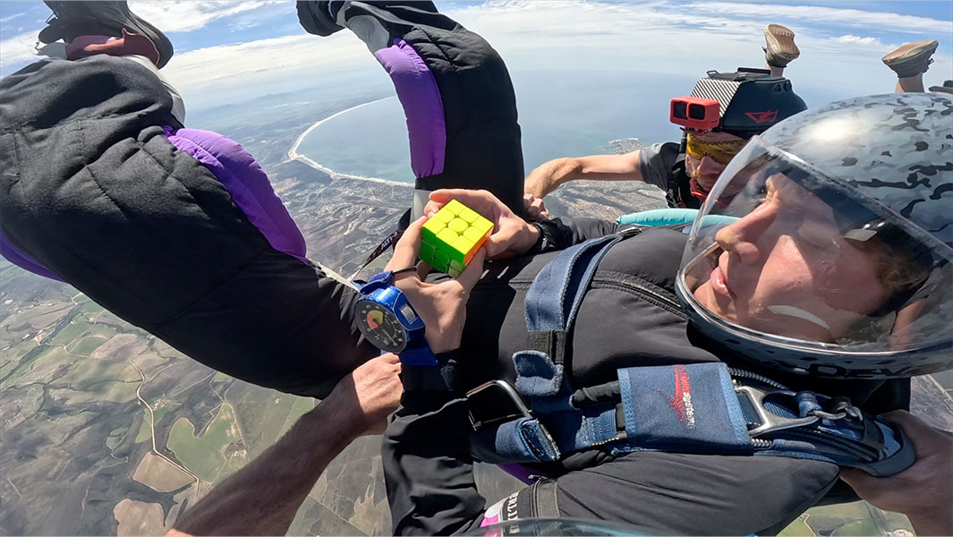 Tom solving a puzzle cube in freefall