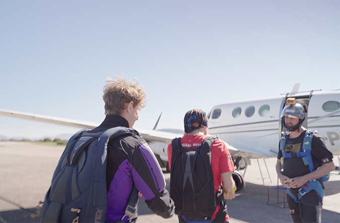 Tom walking towards the plane