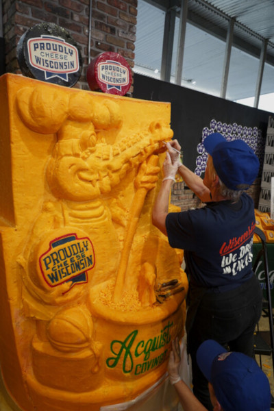 Carving the giant block of cheddar