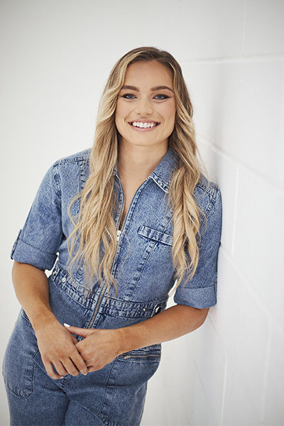 Jodie posing in denim jumpsuit