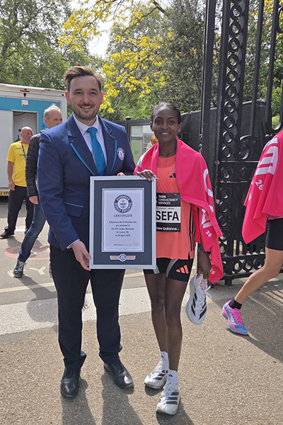 Tigst Assefa  tigst Assefa poses next to guinness world records adjudicator will munford