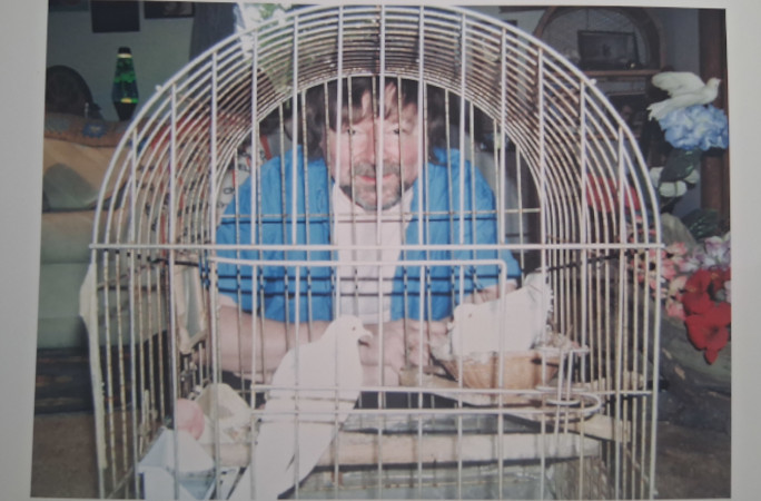 Dewayne and the doves in a cage when younger