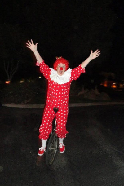 Linda riding by herself dressed as a clown